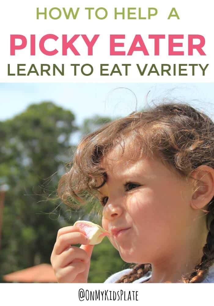 Little girl eats a snack with a smile happily without being a picky eater.