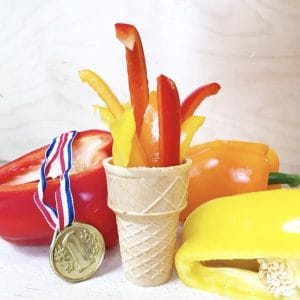 Peppers in an ice cream cone to look like an Olympic torch with an Olympic medal next to it