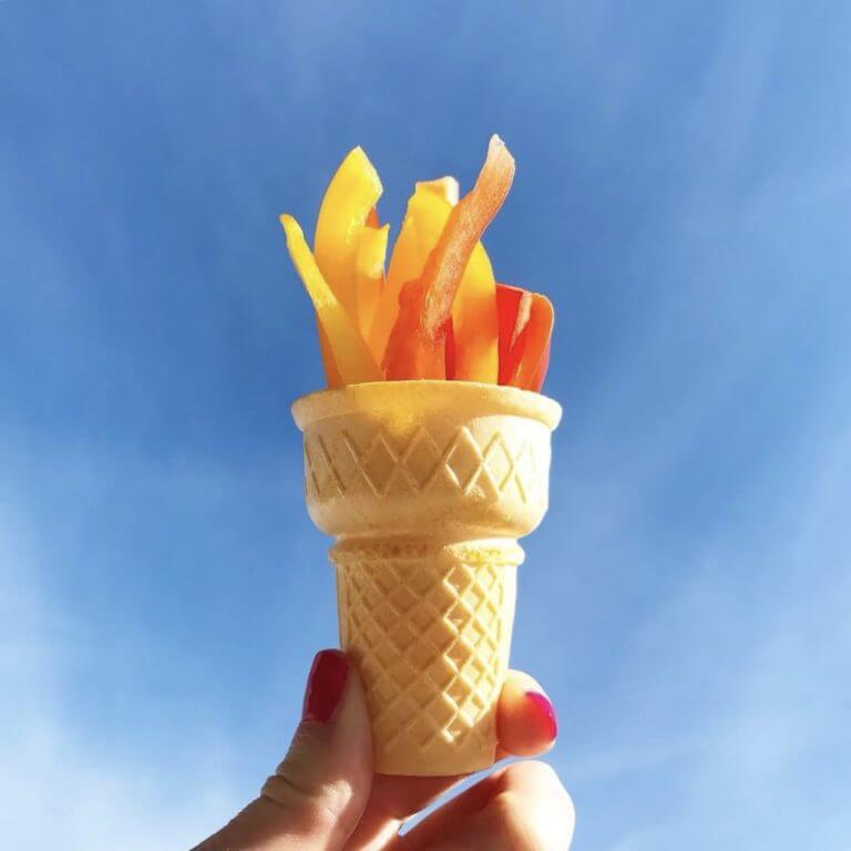 Peppers in an ice cream cone held up in the sky to look like an olympic torch