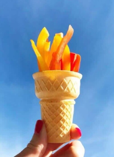 Peppers in an ice cream cone held up in the sky to look like an olympic torch