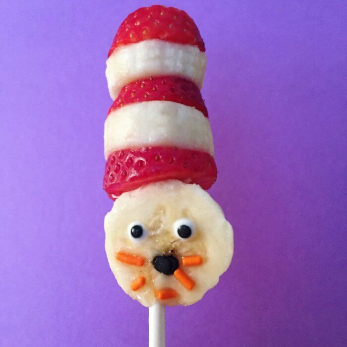 Banana and strawberry sliced to look like The Cat In The Hat on a stick