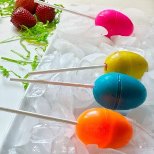 Egg-shaped popsicles on a tray of ice