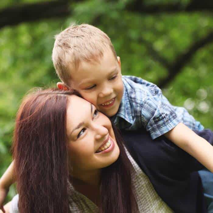 A women with a child on her back laughing