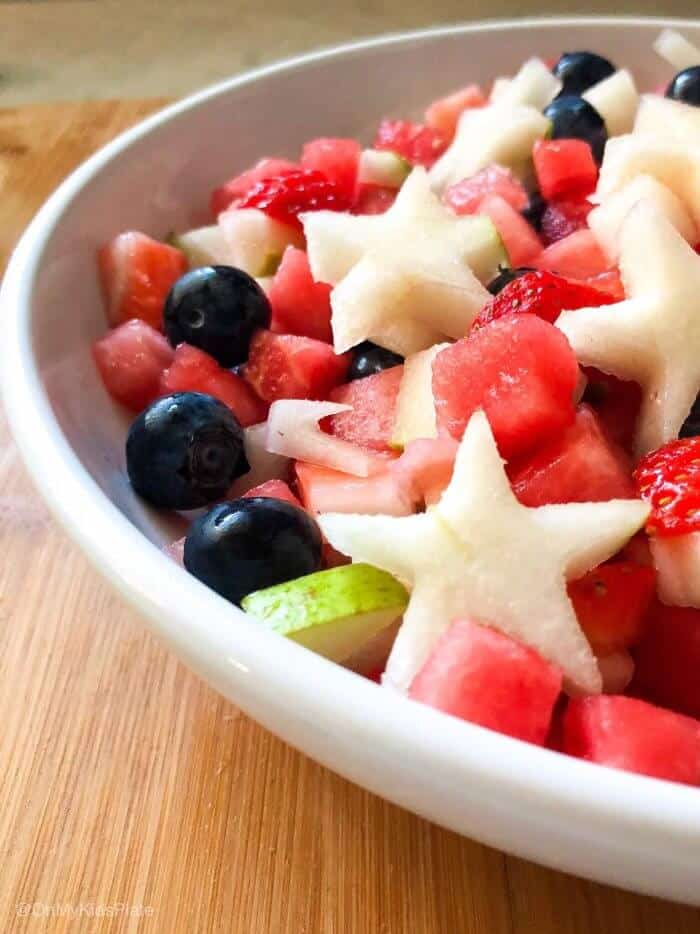 A bowl of fruit salsa topped with pear stars