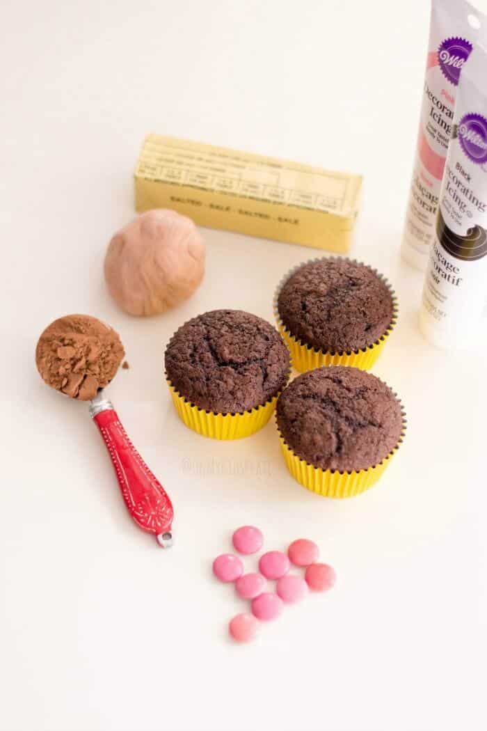 Cupcakes, ingredients for frosting and candy decorations