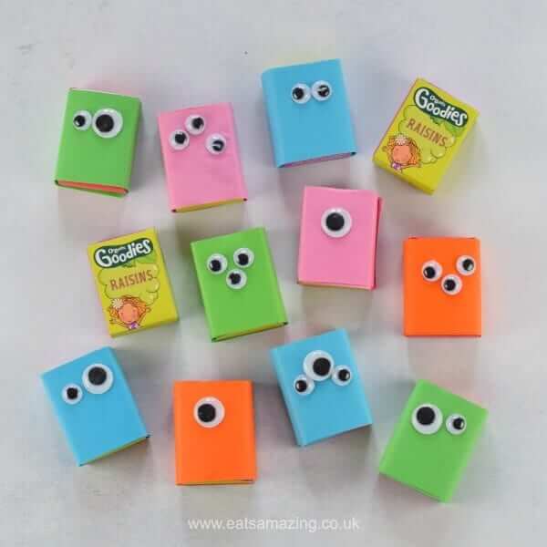 Boxes of raisins wrapped in colored paper and googly eyes to look like monsters