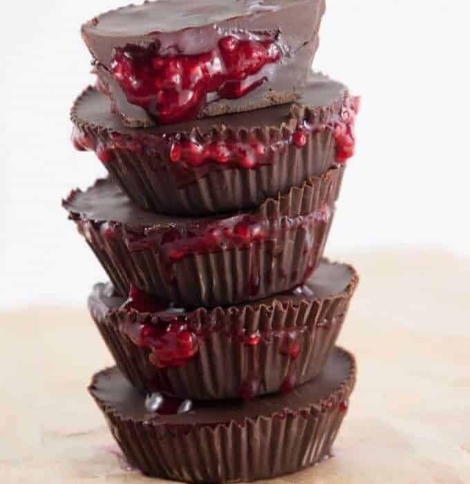 Chocolate cups stacked six high with raspberry filling spilling out to look like blood.