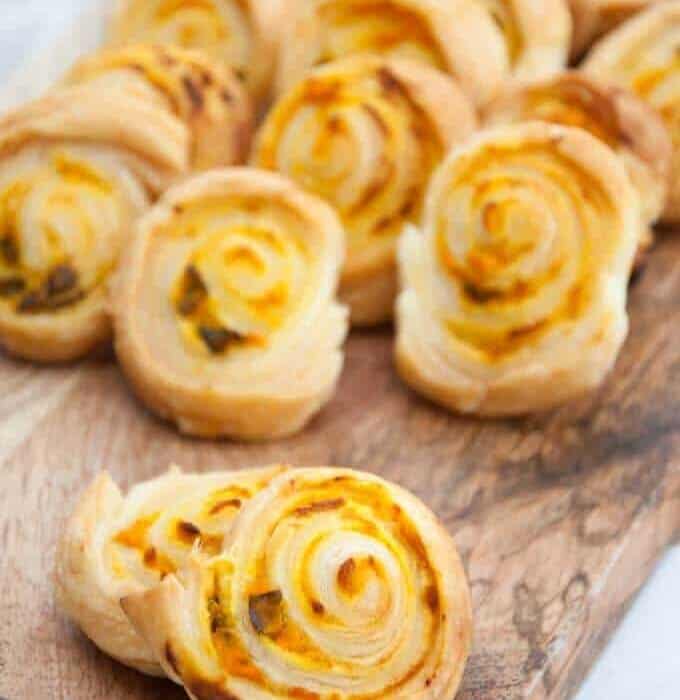 pumpkin basil pinwheels on a cutting board