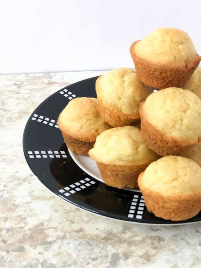 A side view of a plate piled high with sweet cornbread muffins