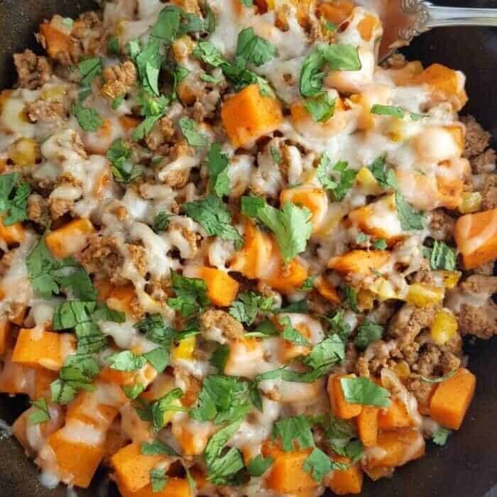 A pan filled with sweet potatoes and ground turkey.