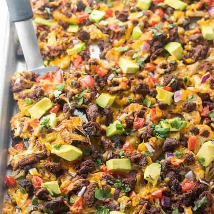 Nachos covered in toppings.