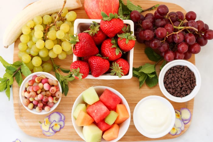 A variety of fruit, chocolate and dips on a table