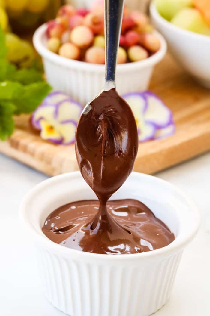 A close of view of melted chocolate being stirred with a spoon