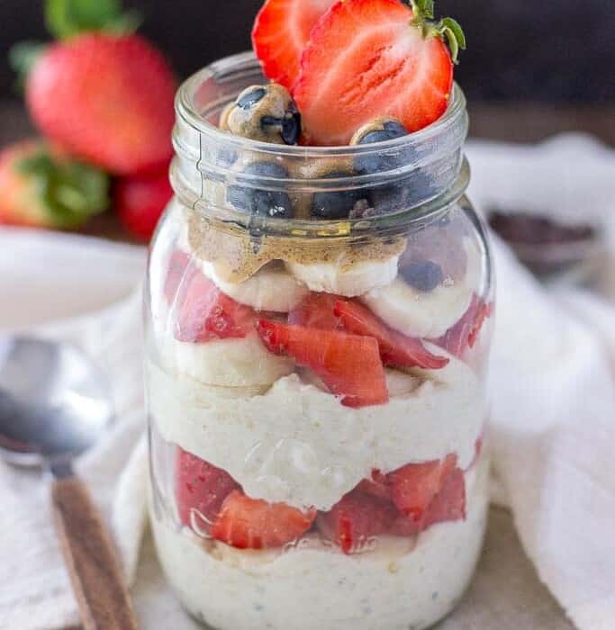 Layered overnight oats with strawberry and blueberries in a jar