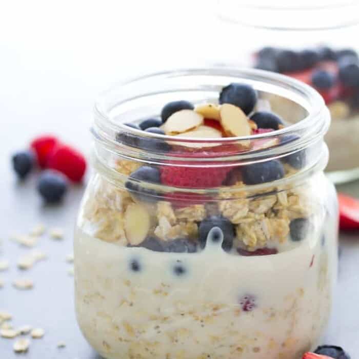 Ovenright oats in a glass jar topped with fruit and nuts