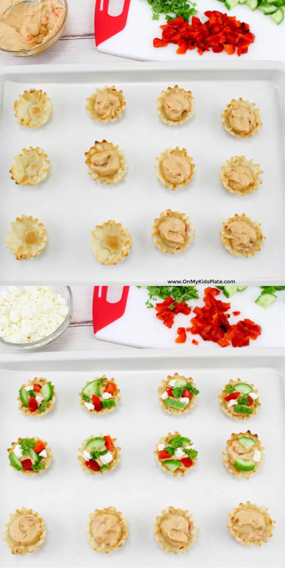 Phyllo cups being filled with hummus, then topped with chopped red pepper, cucumber and parsley from a cutting board and feta cheese from a bowl.