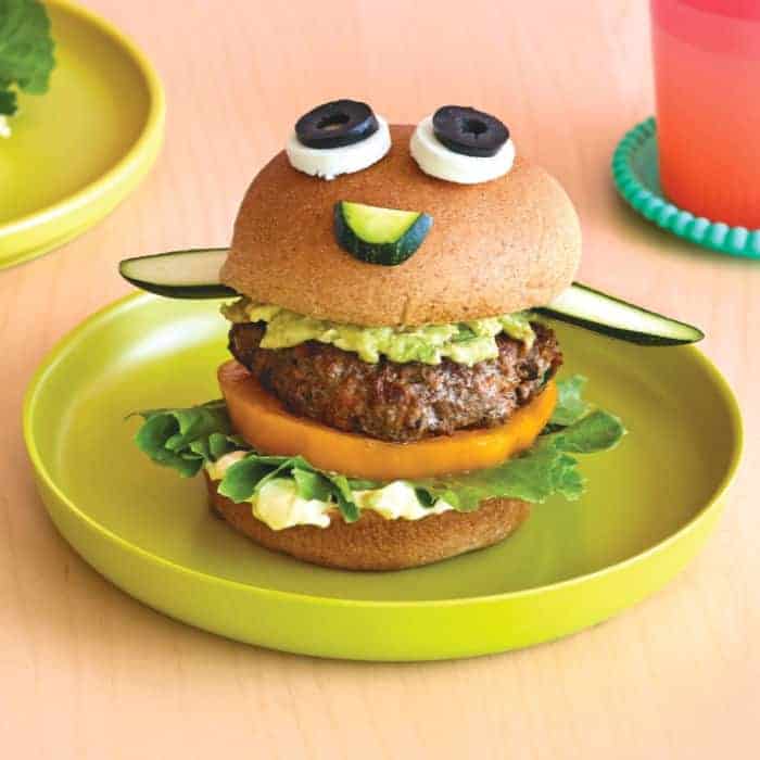 A beef burger made to look like a funny face on a plate