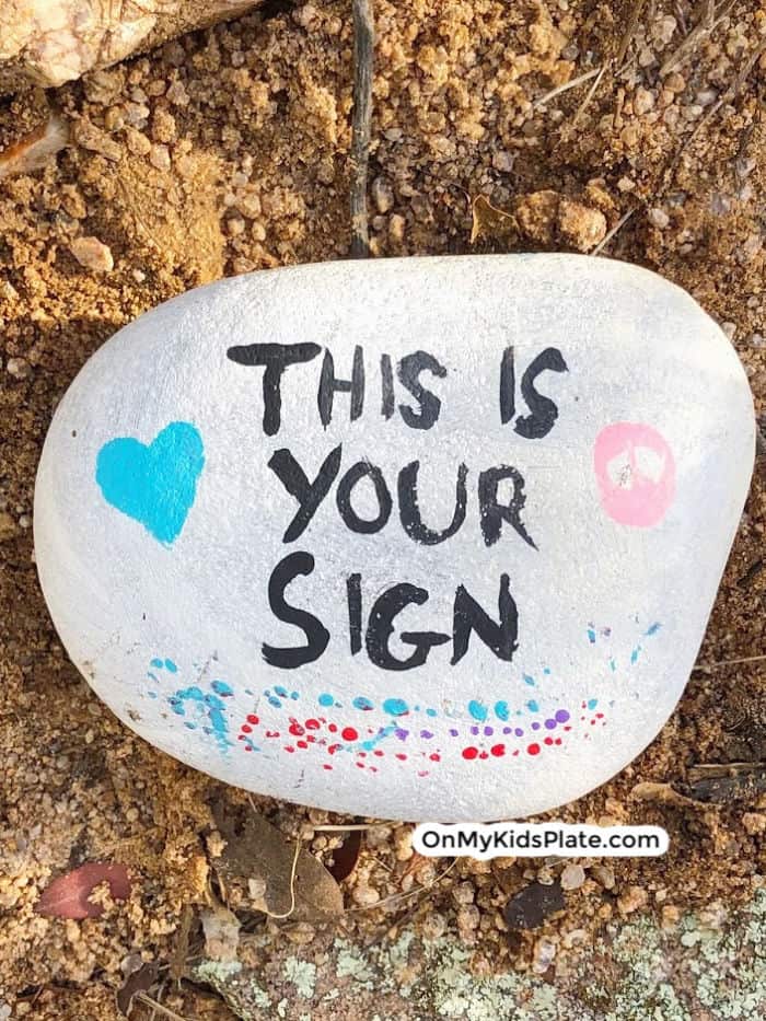 A picture of a painted rock that reads this is your sign.