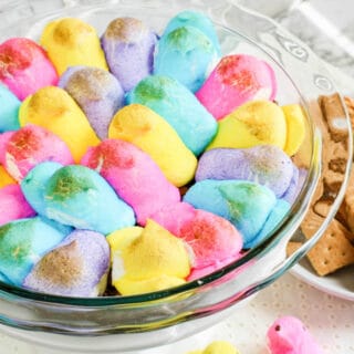 Peeps marshmallows in a bowl toasted brown with graham crackers next to the bowl
