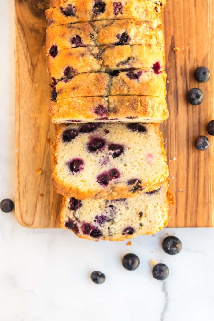 Blueberry bread sliced on a cutting board from overhead