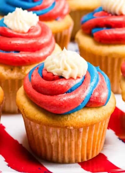 An up close view of a cupcake frosted with red white and blue frosting