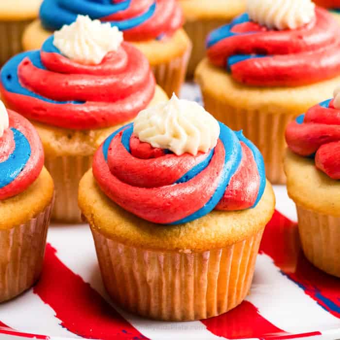 An up close view of a cupcake frosted with red white and blue frosting