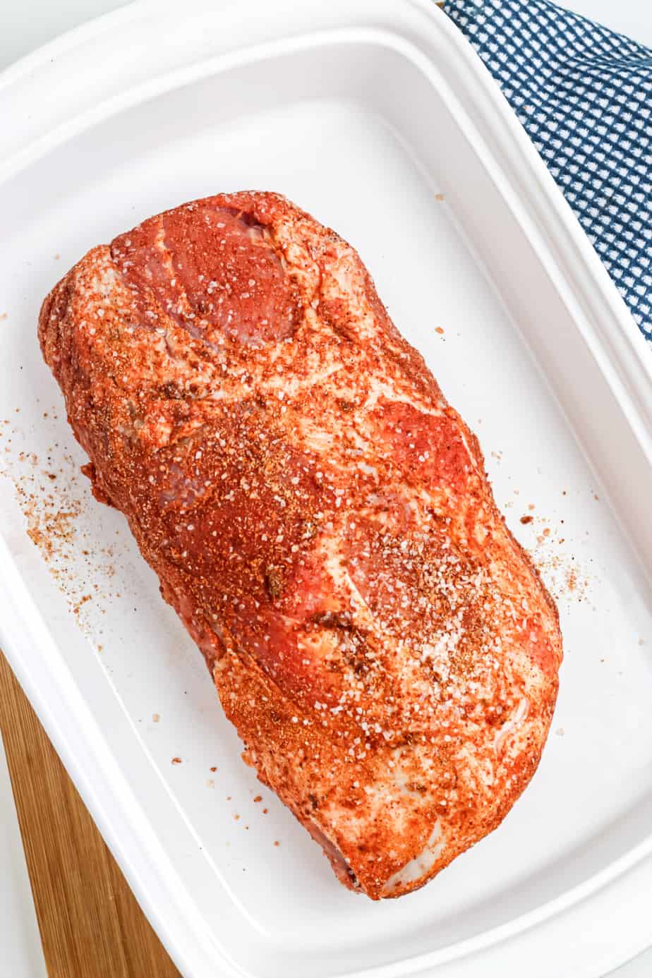 Pork loin covered in spices in a baking pan