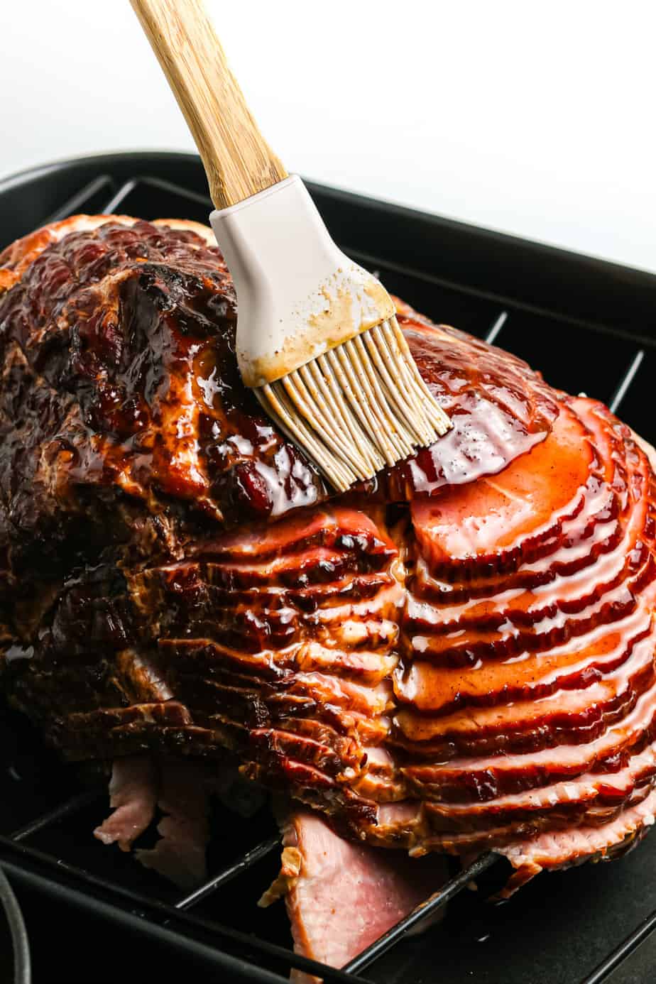 Glazing the ham with a silicone brush