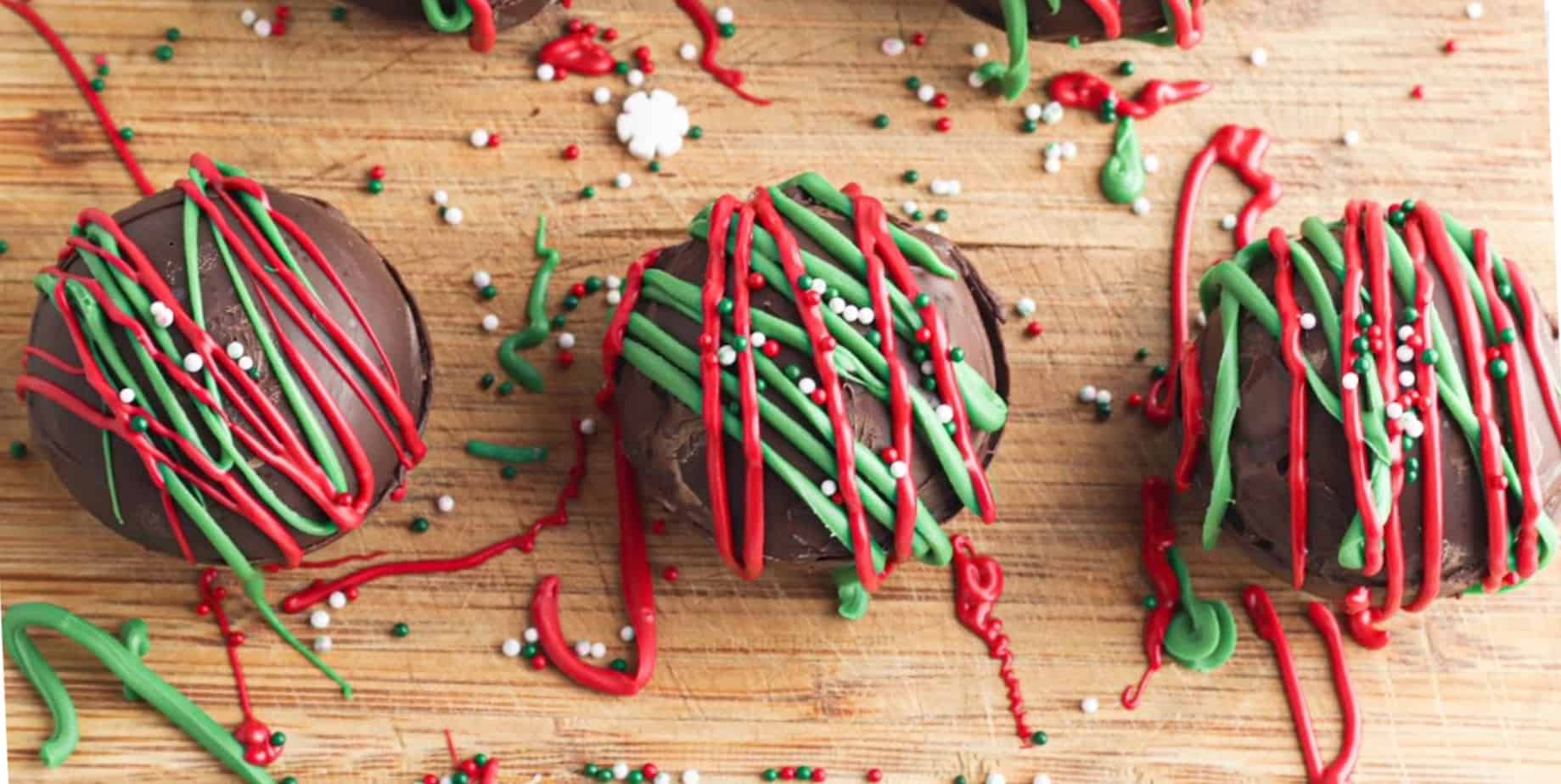 Three decorated hot cocoa bombs with sprinkles