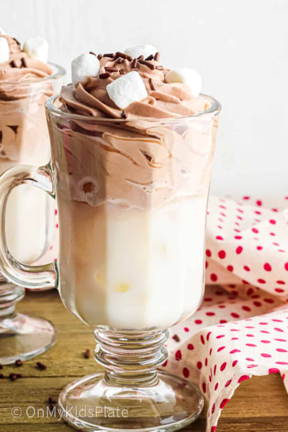 A tall glass of whipped hot chocolate from the side