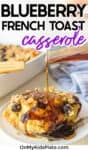 Blueberry french toast casserole being drizzled with maple syrup with text title overlay