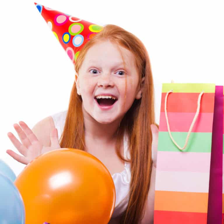 Birthday girl with hat and presents laughing