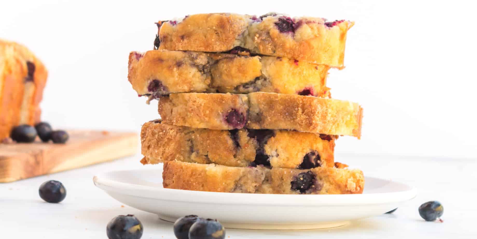 tall stack of sliced blueberry bread on a plate