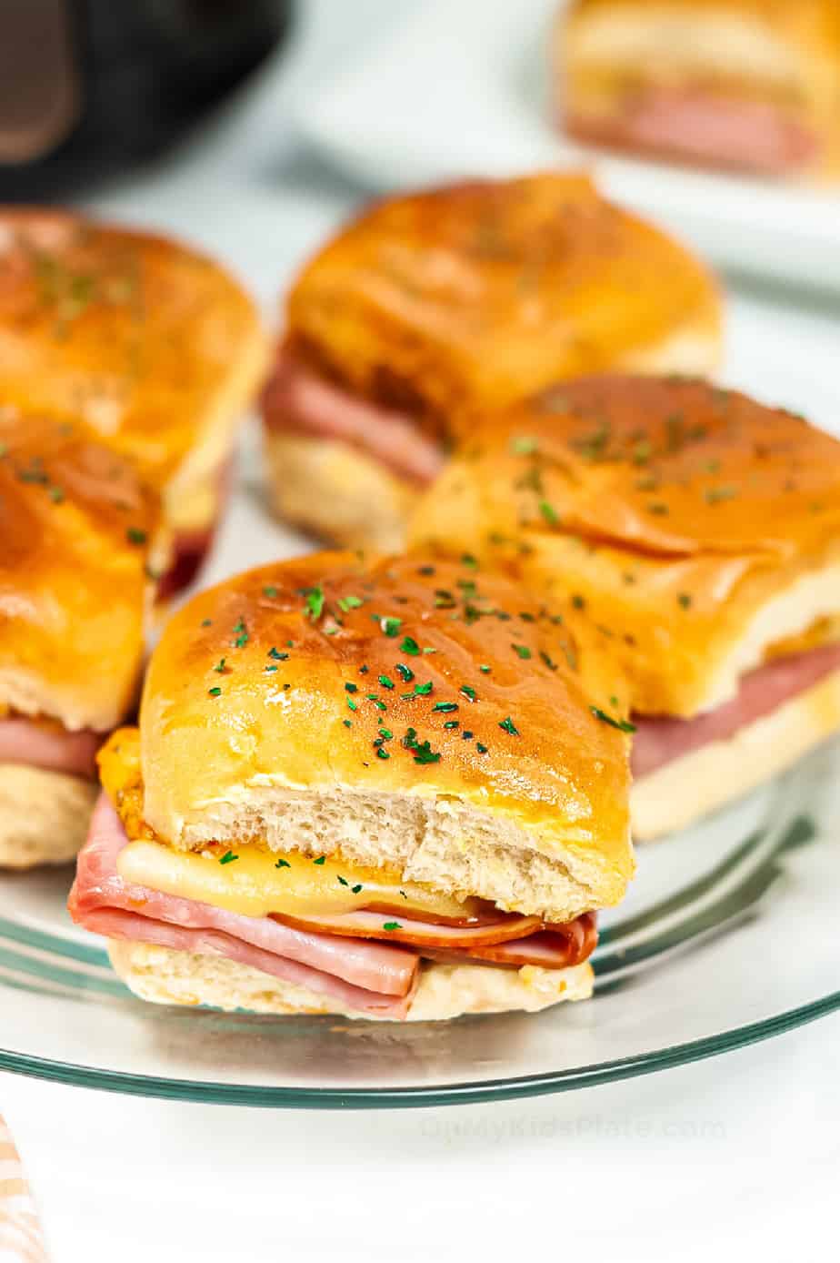 Platter of melty ham and cheese sliders