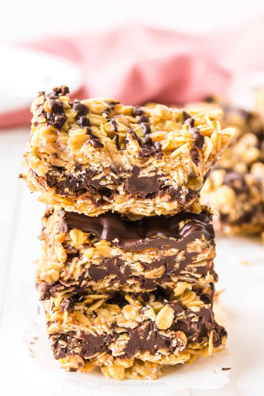 Stack of chocolate oatmeal bars from the side stacked three bars high.