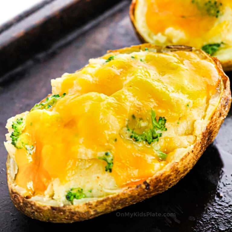 Close up of a broccoli cheese stuffed potato on a baking sheet