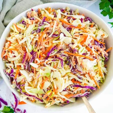 Coleslaw in a bowl form overhead with a serving spoon