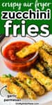 Close up of a plate of zucchini fries with one in a bowl of marinara. Text title overlay that says crispy air fryer zucchini fries is at the top of the image.