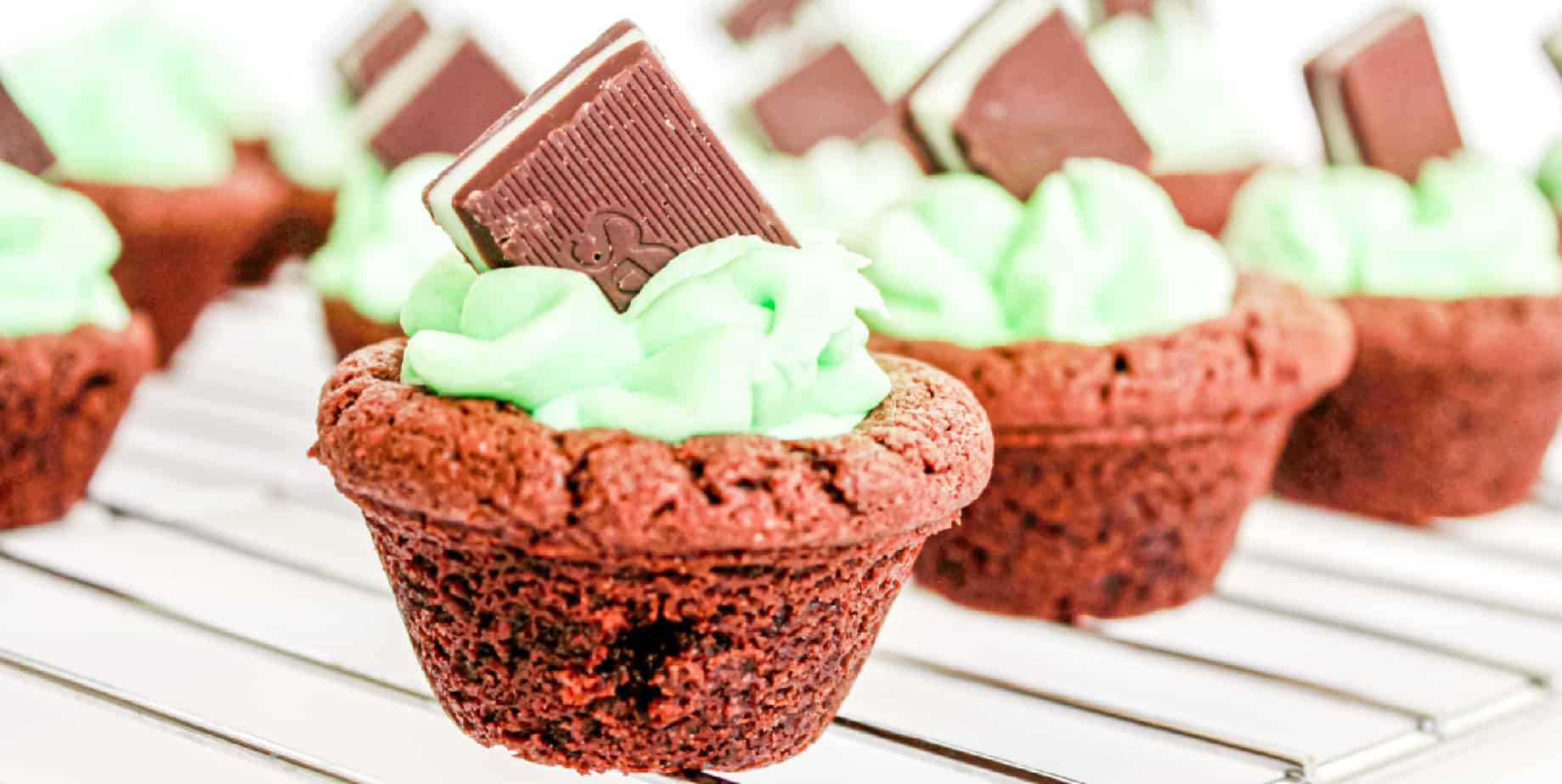 Wide view of chocolate cookies full of frosting and Andes candies