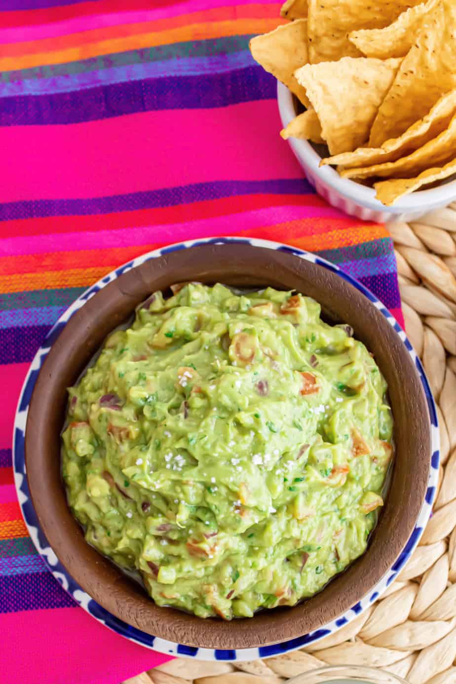 Guacamole in a bowl from overhead with a bowl of chips