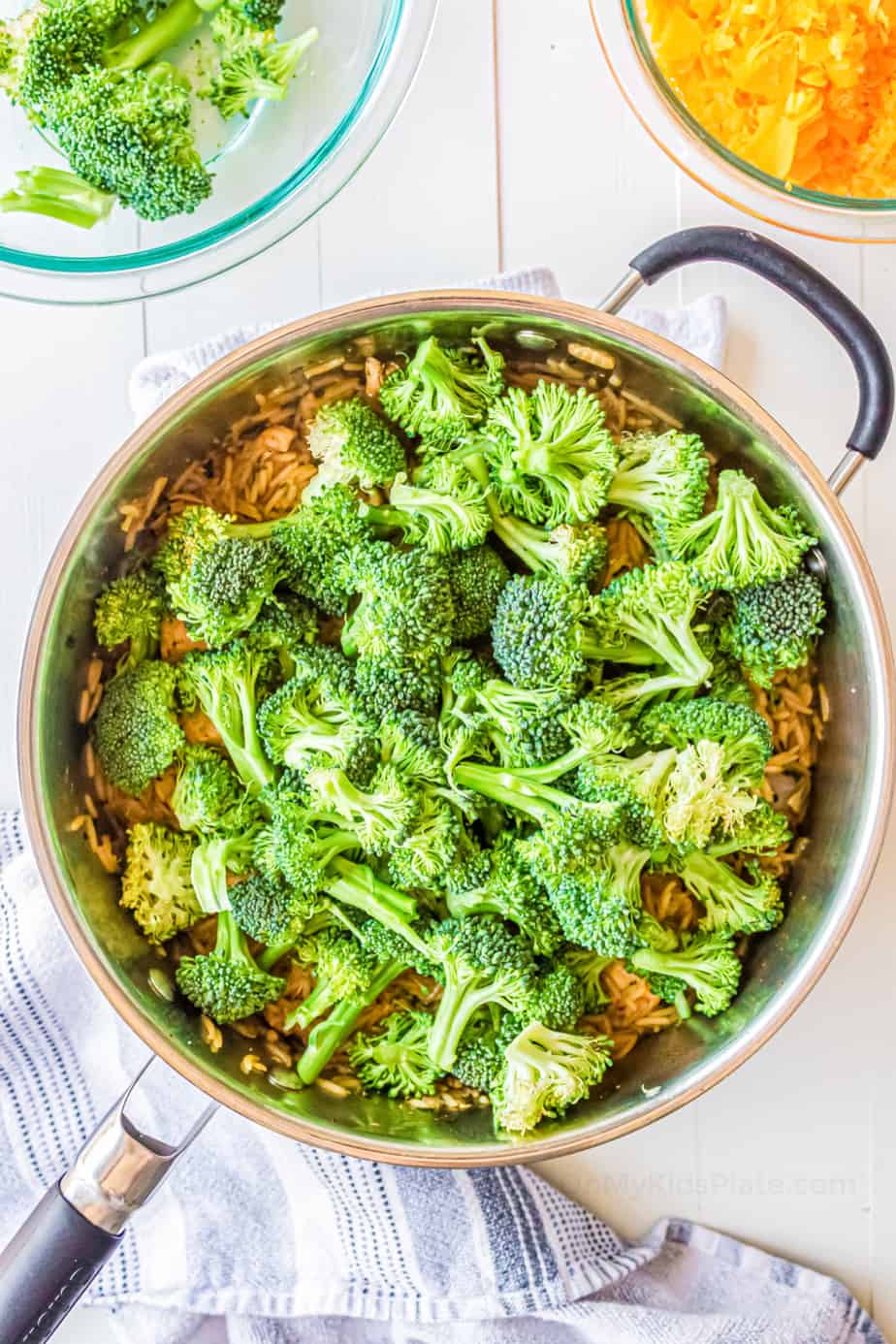 Broccoli in a pan from overhead over top of cooked rice.