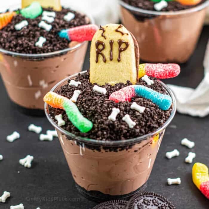 Chocolate pudding cups decorated to look like tombstones, dirt and worms