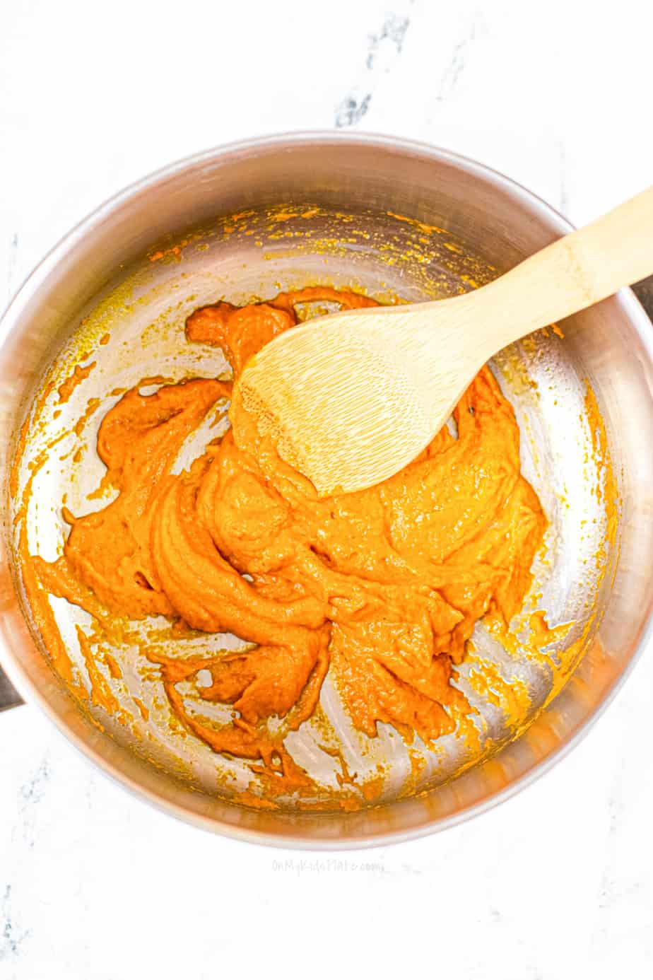 melting butter and pumpkin puree together in a pan
