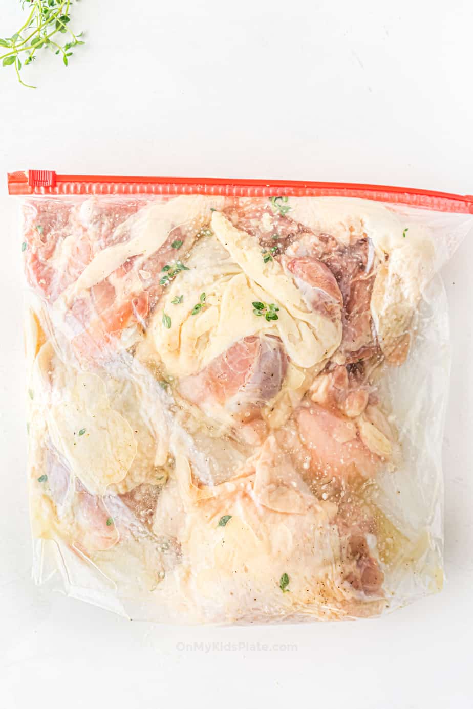 Chicken thighs in a large zip top bag in marinade