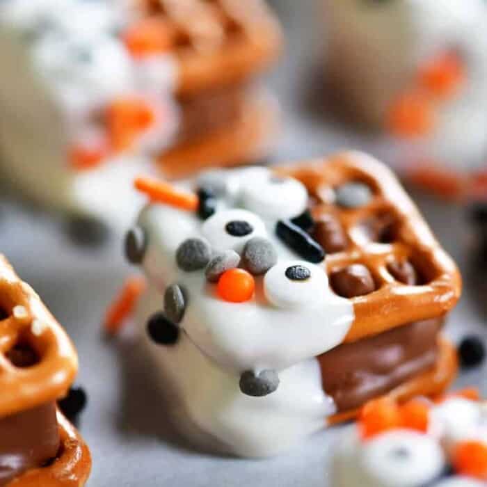 Square pretzels with a candy bar melted in between and dipped in chocolate and decorated with halloween sprinkes
