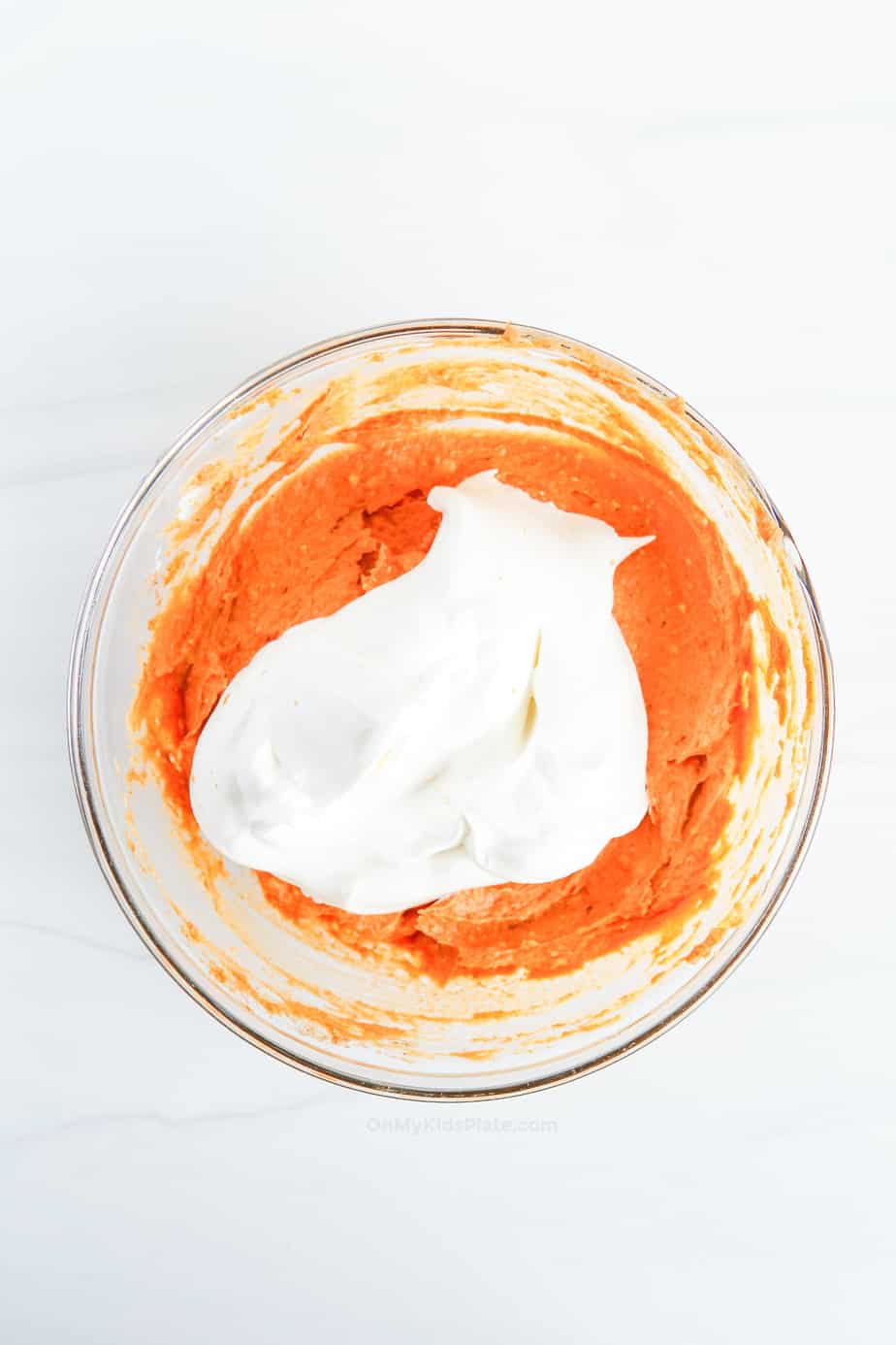 Adding whipped topping and mixing in to the pumpkin dip