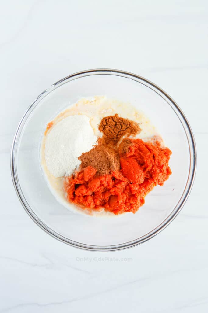 Pumpkin, pumpkin spice, instant pudding mix and milk all in a bowl together to make pumpkin pie dip.