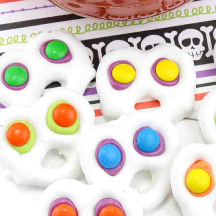 White chocolate covered pretzels with brightly colored eyes to look like screaming ghosts