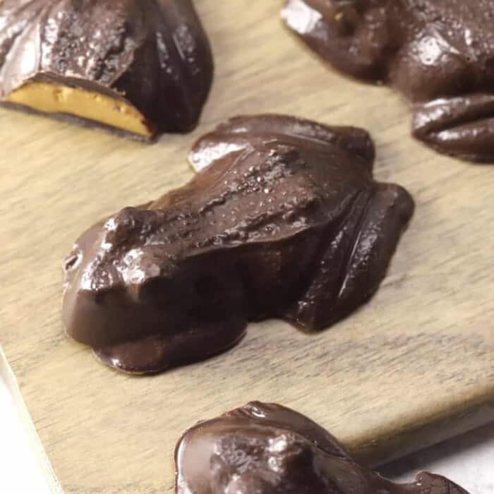 Chocolate peanut butter frog candies on a cutting board up close