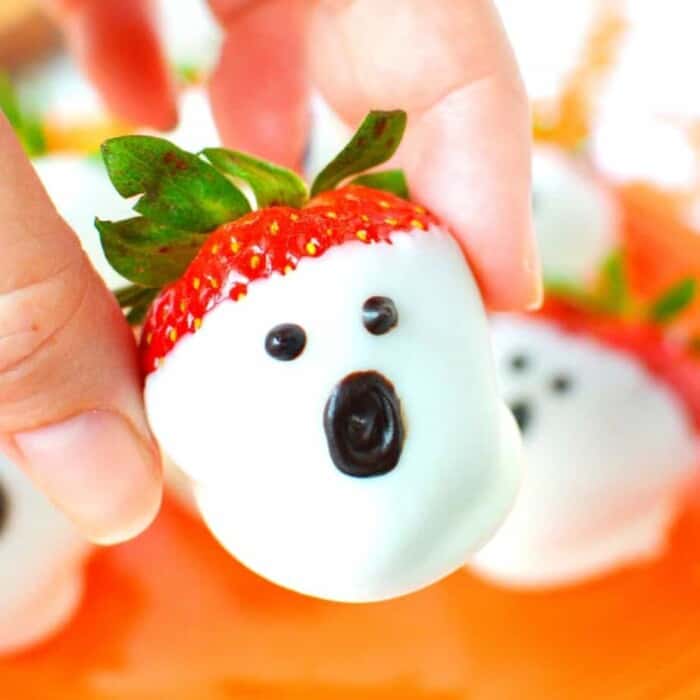 Strawberries dipped in white chocolate and decorated to look like ghosts
